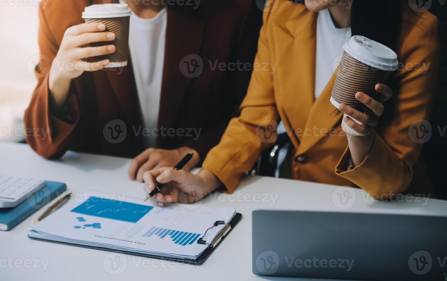 Beautiful young smiling Asian businesswoman working on laptop and drinking coffee, Asia businesswoman working document finance and calculator in her office. photo