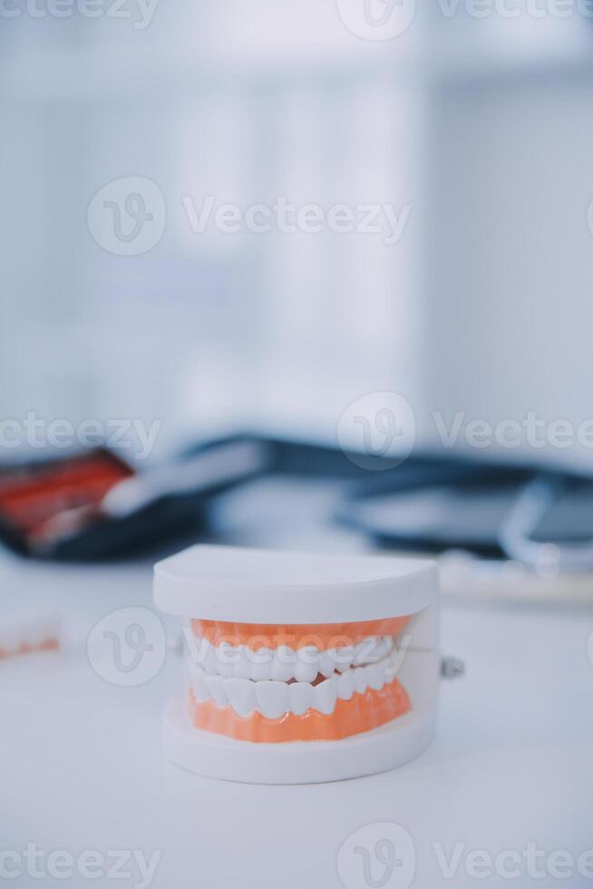 Denture and dental tools,dental mirror on white background photo