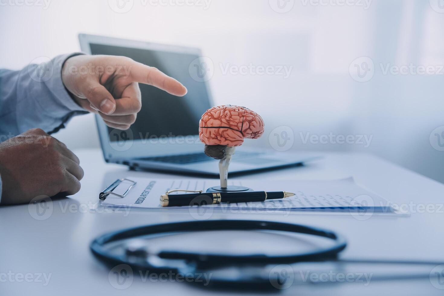 Doctor explaining brain functions to patient on model in office. photo