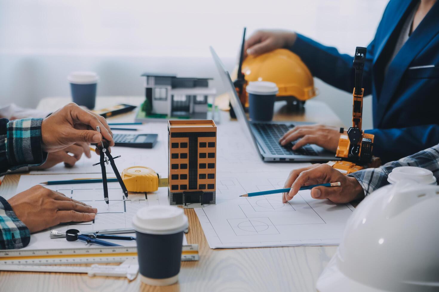 Image of engineer meeting for architectural project. working with partner and engineering tools on workplace vintage tone. photo