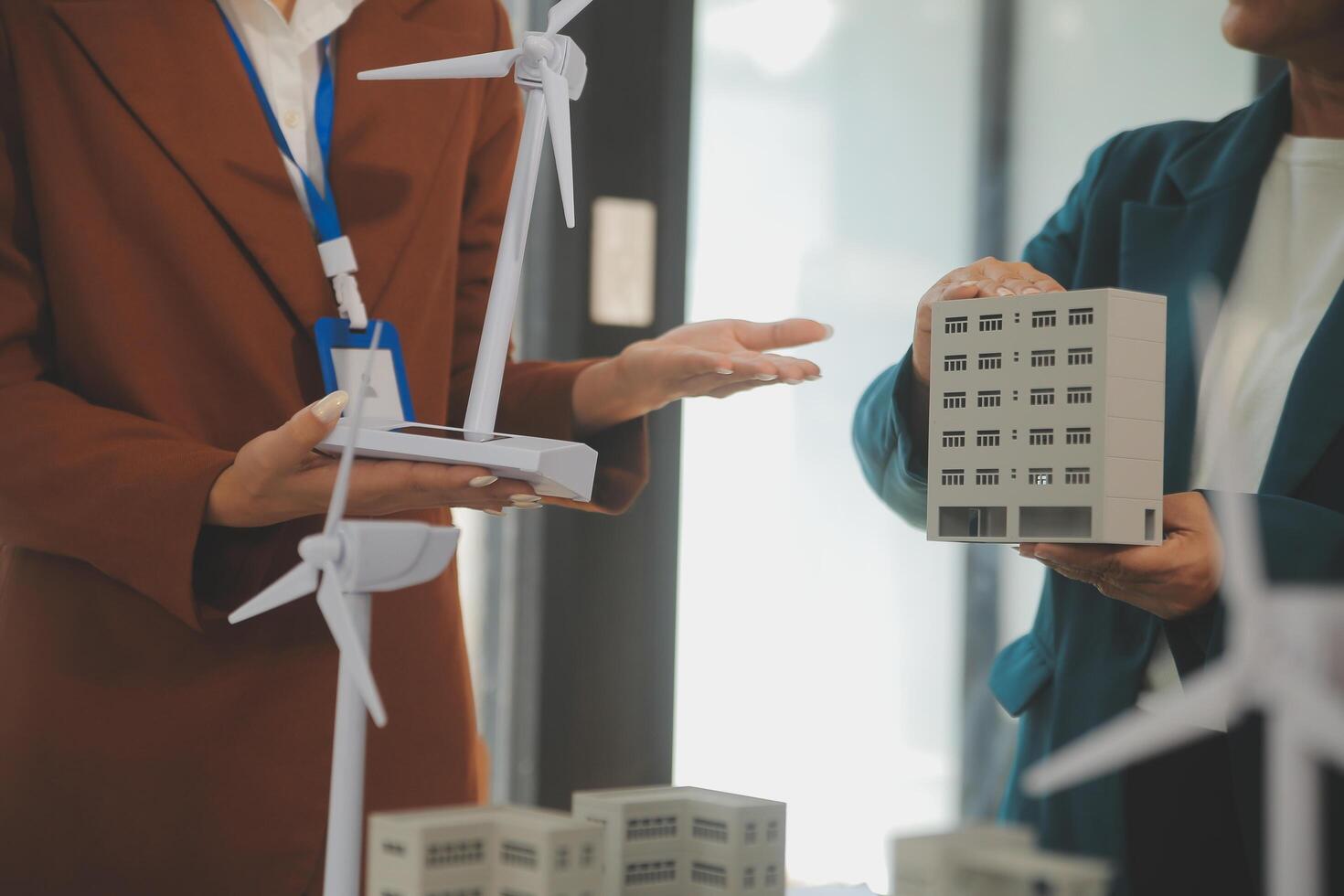 Close-up at tablet, Engineers pointing at tablet with their hands. To jointly design the use of renewable energy with wind and solar energy. Concept of using renewable energy. photo