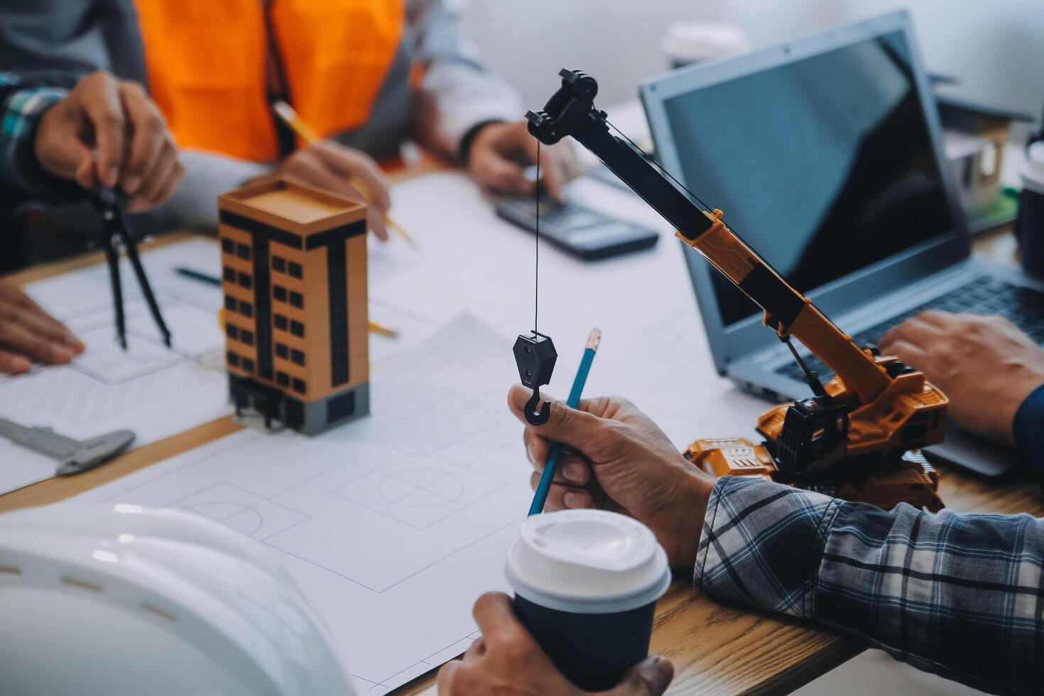 Image of engineer meeting for architectural project. working with partner and engineering tools on workplace vintage tone. photo