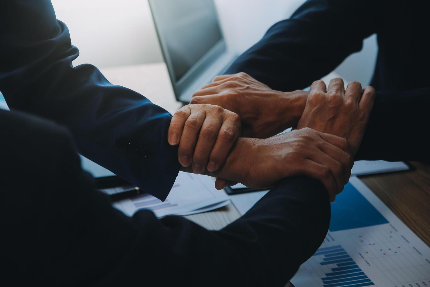 Business people join hands to join forces as a teamwork. photo