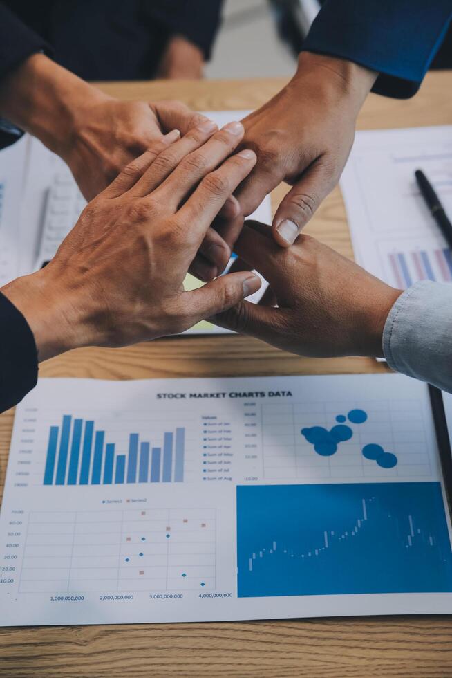 Business people join hands to join forces as a teamwork. photo