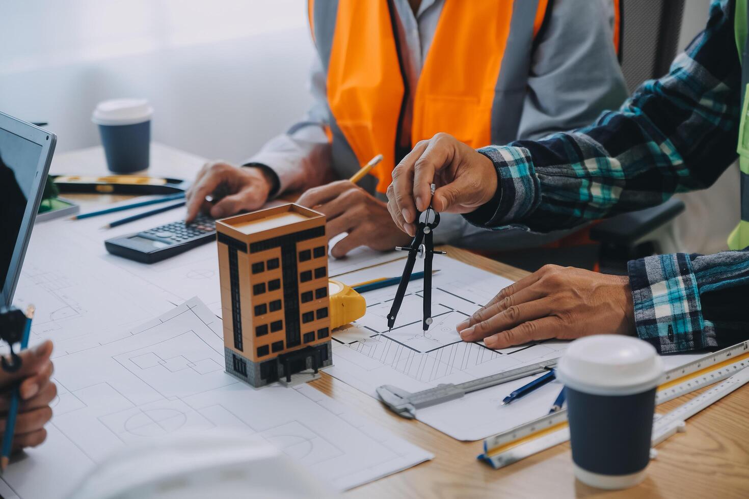 Image of engineer meeting for architectural project. working with partner and engineering tools on workplace vintage tone. photo