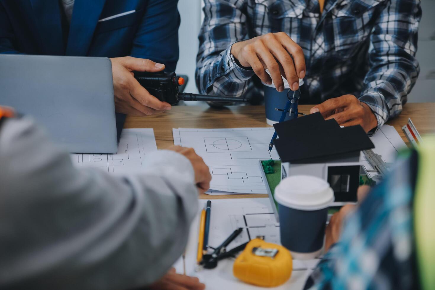 imagen de ingeniero reunión para arquitectónico proyecto. trabajando con compañero y Ingenieria herramientas en lugar de trabajo Clásico tono. foto