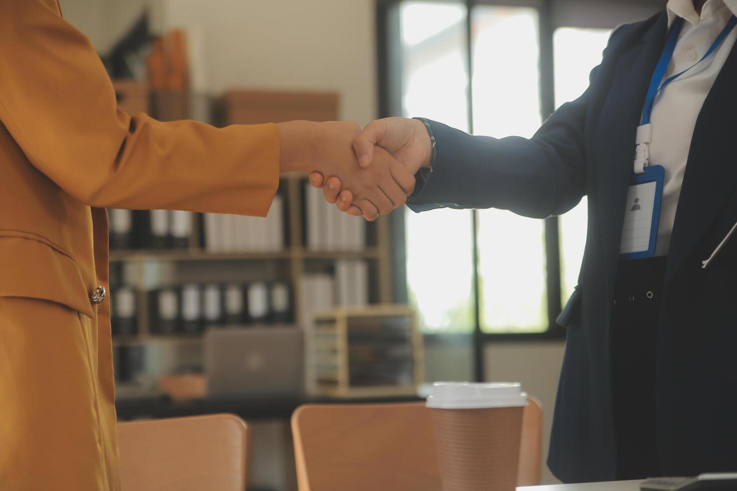 Real estate broker agent and customer shaking hands after signing contract documents for realty purchase, Bank employees congratulate, Concept mortgage loan approval. photo