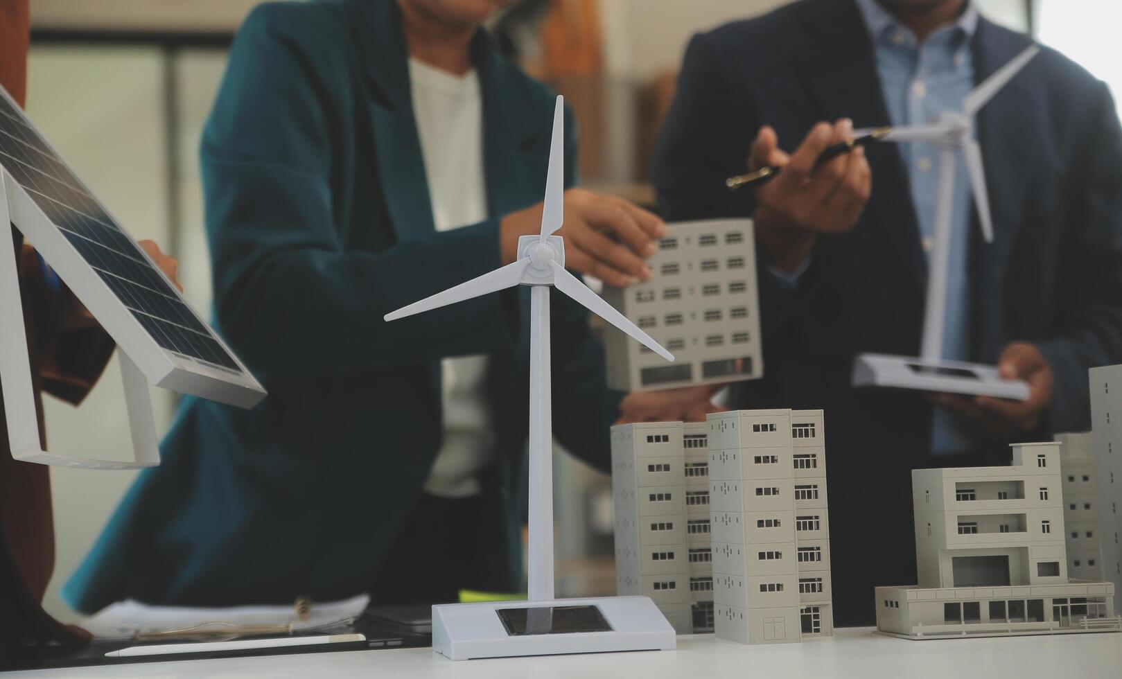 Close-up at tablet, Engineers pointing at tablet with their hands. To jointly design the use of renewable energy with wind and solar energy. Concept of using renewable energy. photo