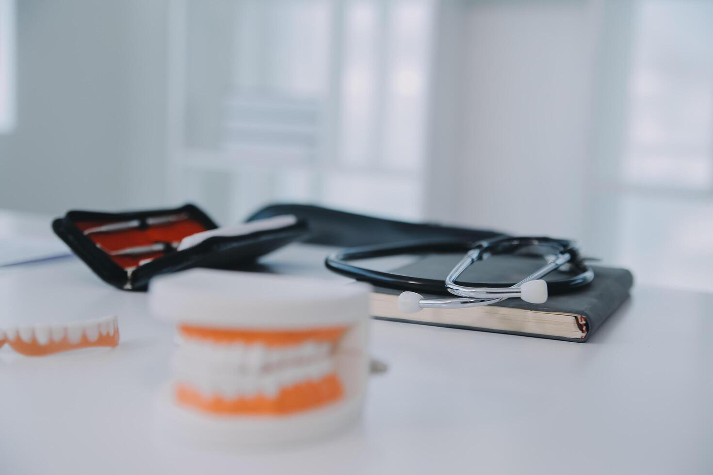 Denture and dental tools,dental mirror on white background photo