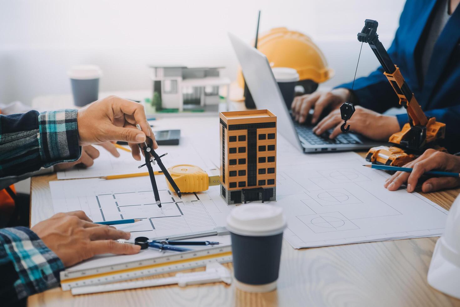 Image of engineer meeting for architectural project. working with partner and engineering tools on workplace vintage tone. photo