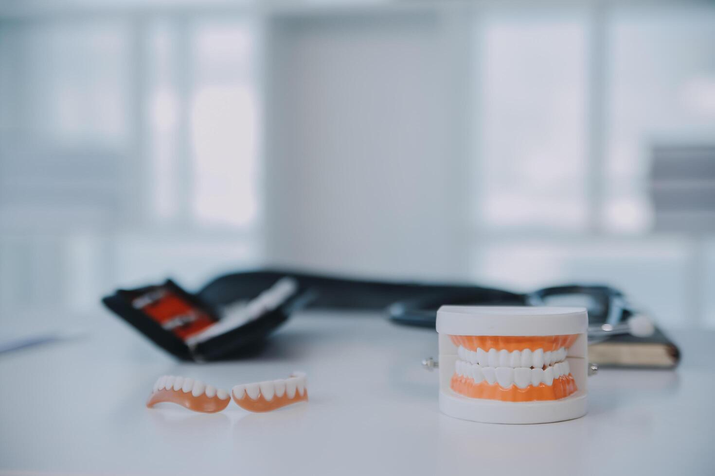 Denture and dental tools,dental mirror on white background photo