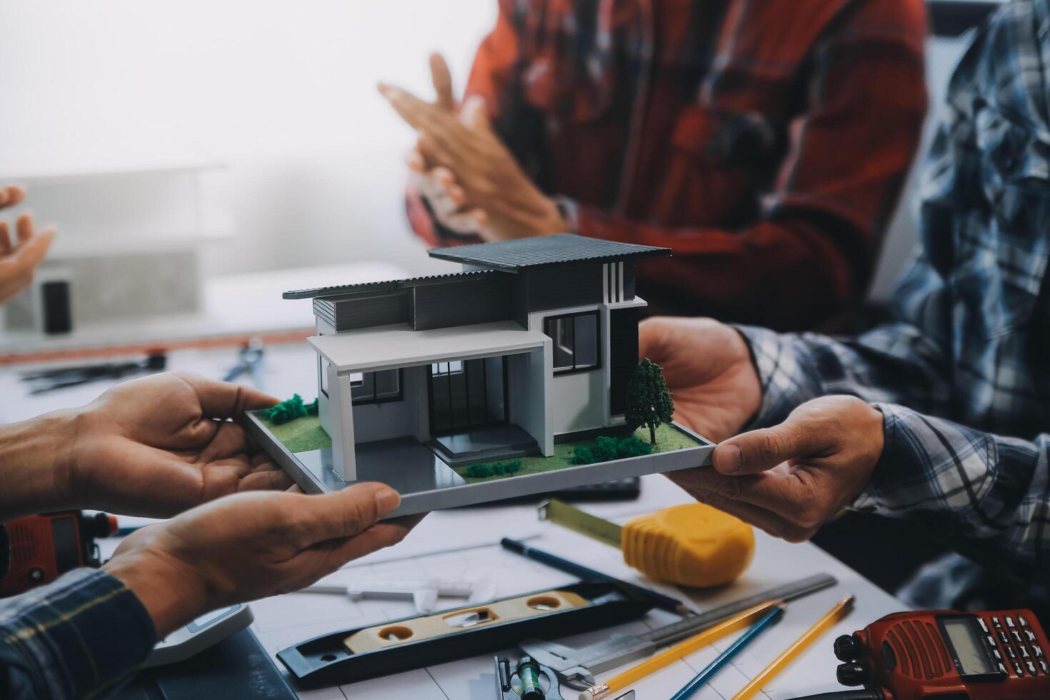 engineer people meeting working and pointing at a drawings in office for discussing. Engineering tools and construction concept. photo