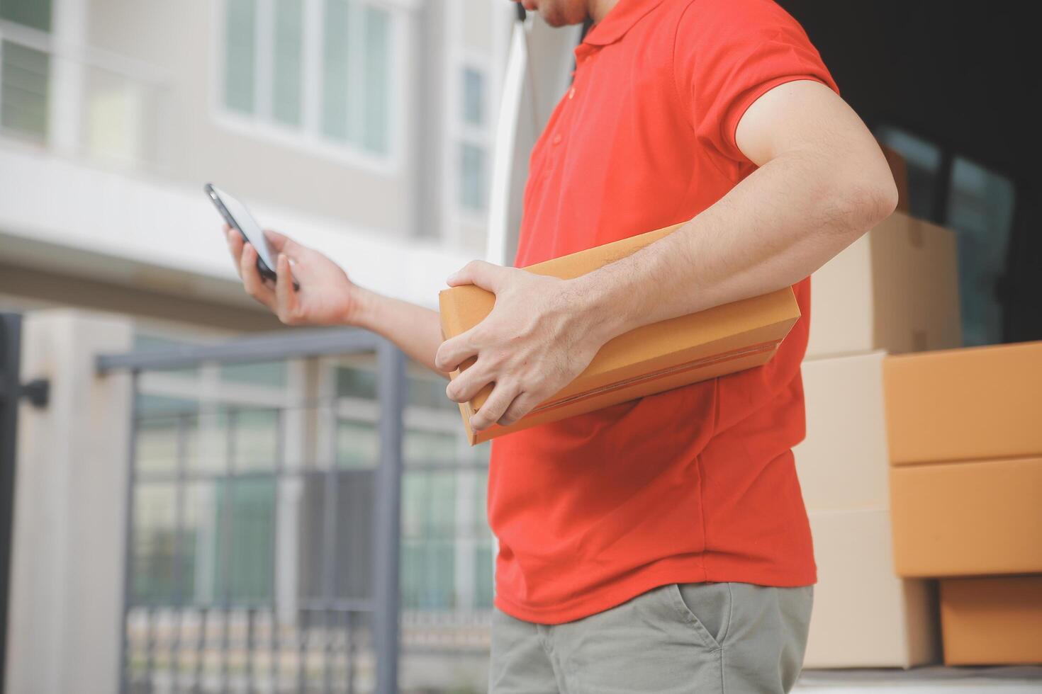 Asian delivery express courier young man use giving boxes to woman customer he wearing protective face mask at front home photo