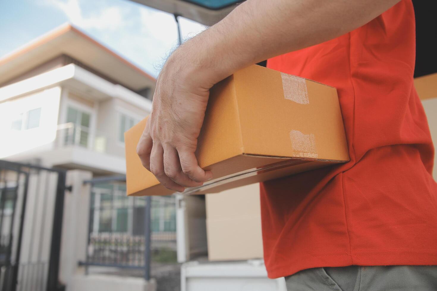 Asian delivery express courier young man use giving boxes to woman customer he wearing protective face mask at front home photo