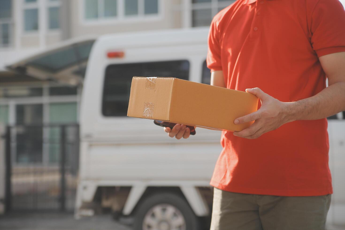 Asian delivery express courier young man use giving boxes to woman customer he wearing protective face mask at front home photo