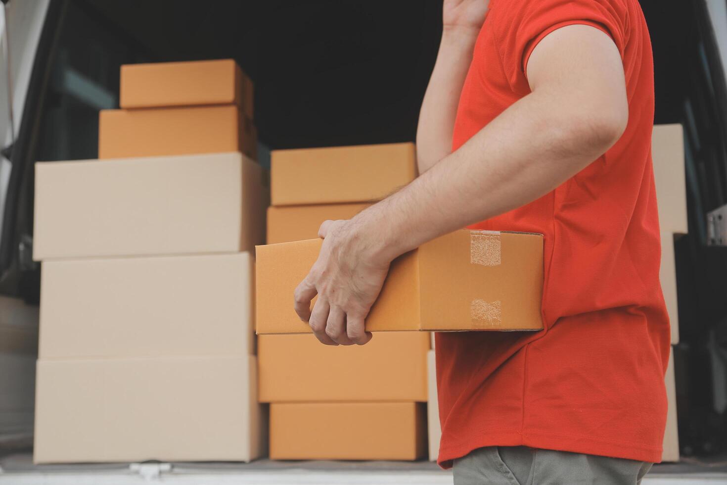 Asian delivery express courier young man use giving boxes to woman customer he wearing protective face mask at front home photo