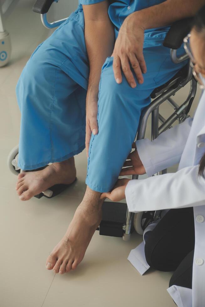 young asian physical therapist working with senior woman on walking with a walker photo