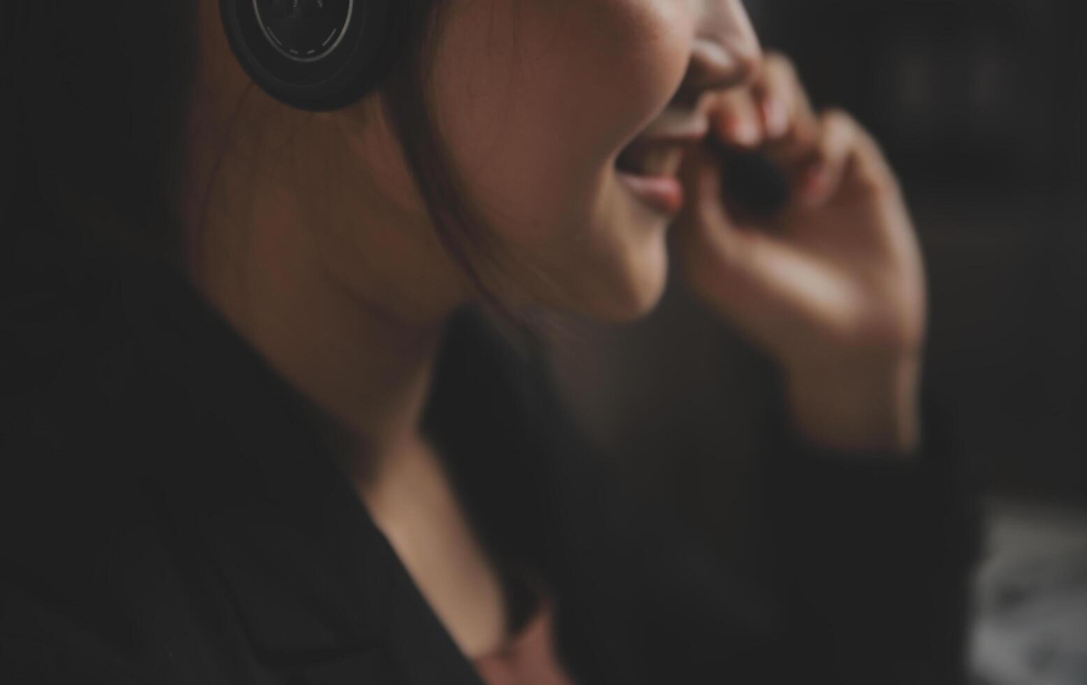 Young woman working in call centre, surrounded by colleagues photo