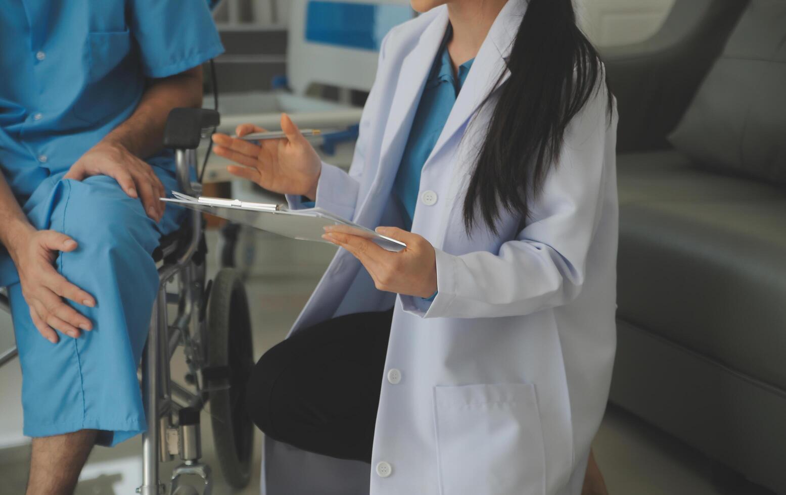 young asian physical therapist working with senior woman on walking with a walker photo