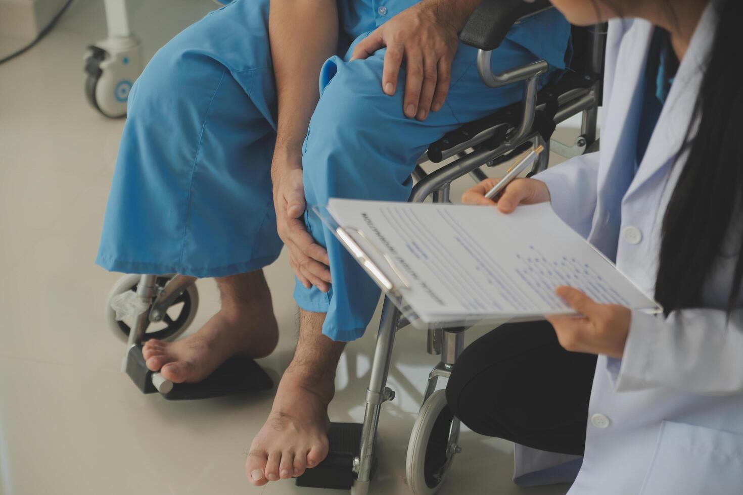 young asian physical therapist working with senior woman on walking with a walker photo