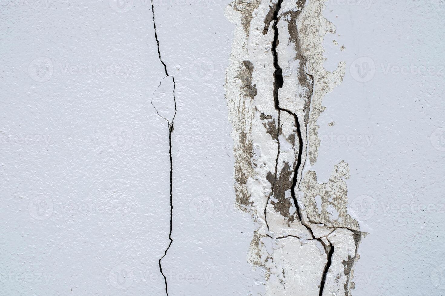 Cracked concrete wall broken wall at the outside cement corner that effected with earthquake and collapsed ground photo