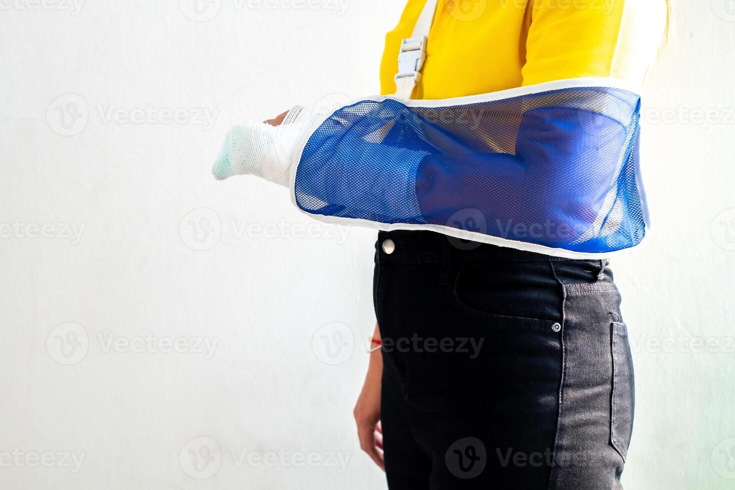 Woman's hand wrapped in white bandage from accident, injury, accident insurance, soft splint on finger, copy space photo