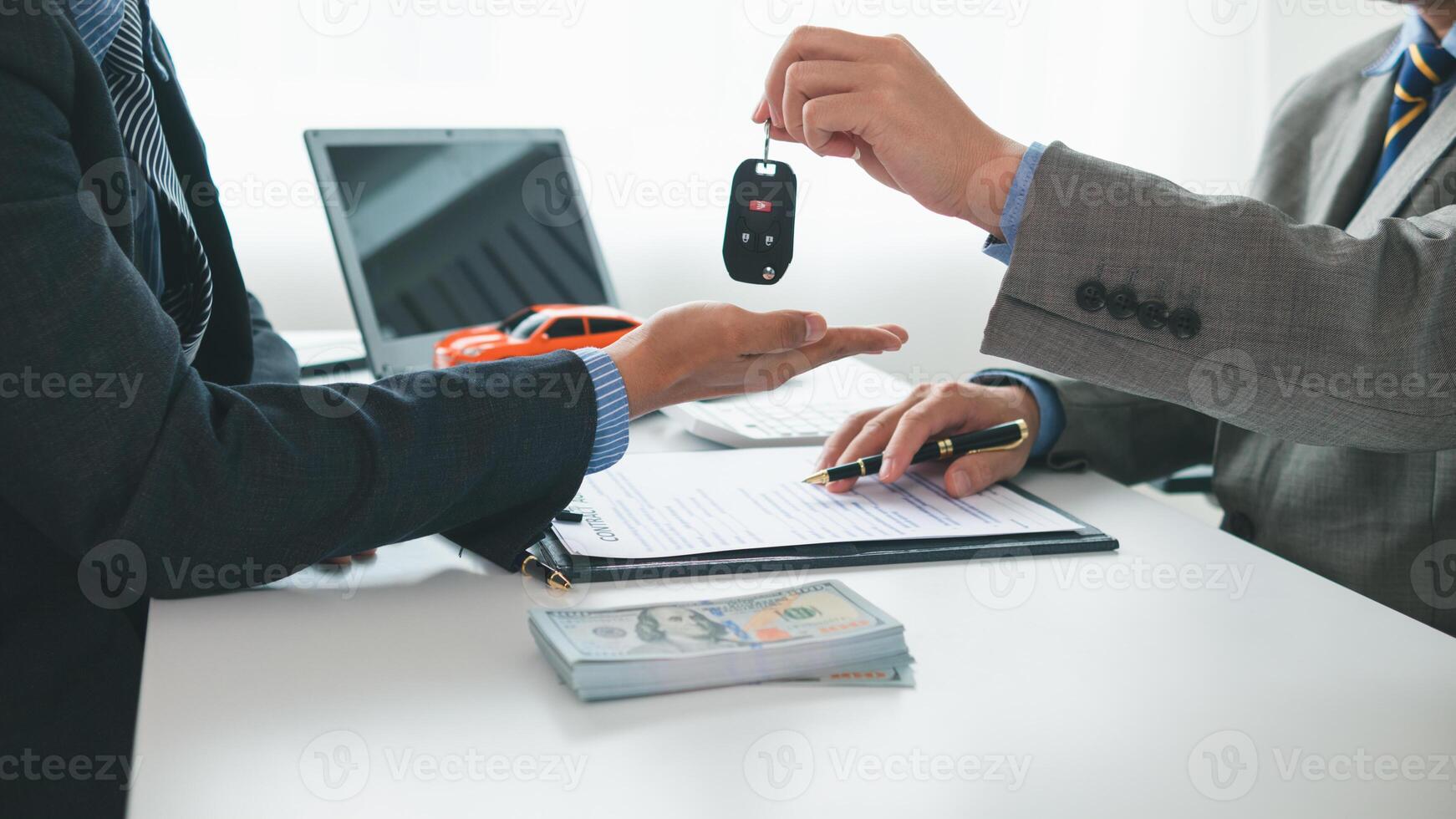 car dealer is handing over car keys to customer after sales contract and installment contract have been signed. Concept of handing over car keys to customers after the sales contract has been approved photo