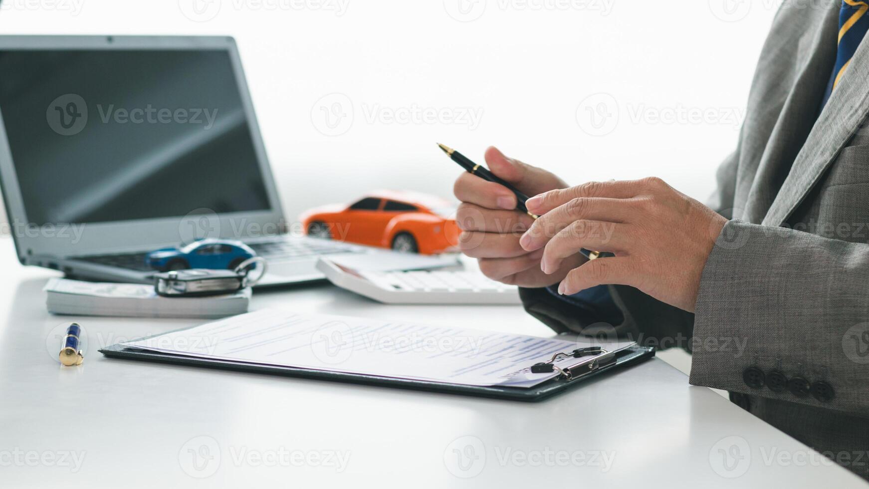 Car dealers recommend car to customers before entering into sales contracts so that customers can get the car they like before paying contract money. Concept of making sales contract with distributor photo