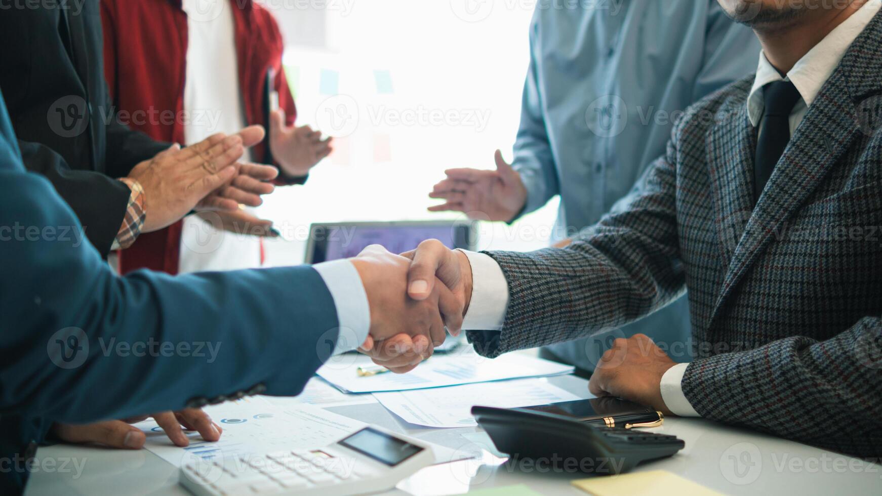 committee of businessmen and investors join hands as symbol of joint investment after discussing consulting and making contract  invest in business together. committee joins hands in meeting. photo