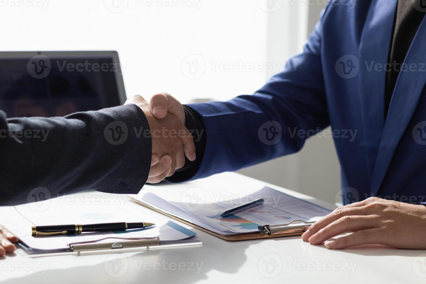 committee of businessmen and investors join hands as symbol of joint investment after discussing consulting and making contract  invest in business together. committee joins hands in meeting. photo