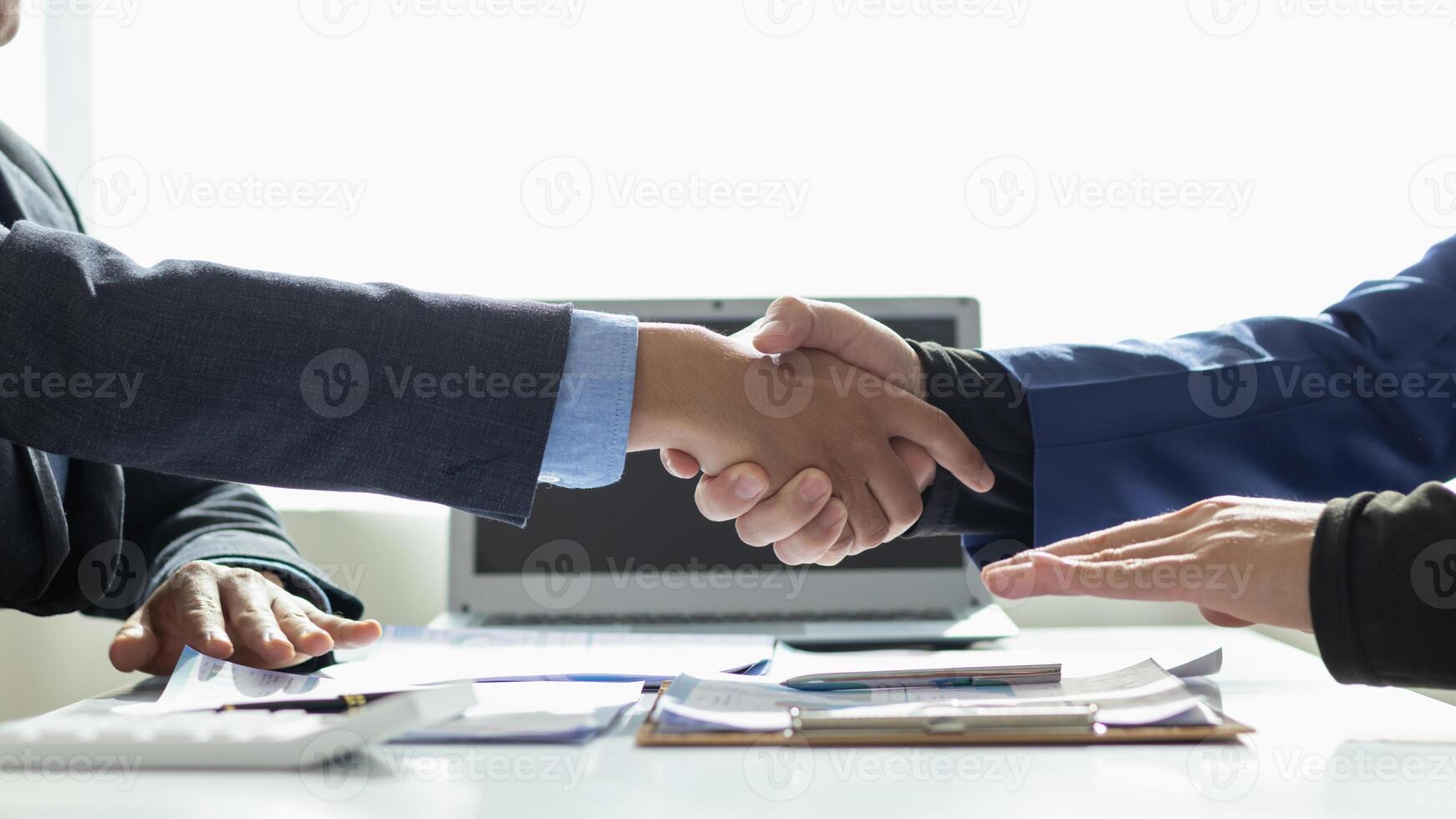 committee of businessmen and investors join hands as symbol of joint investment after discussing consulting and making contract  invest in business together. committee joins hands in meeting. photo