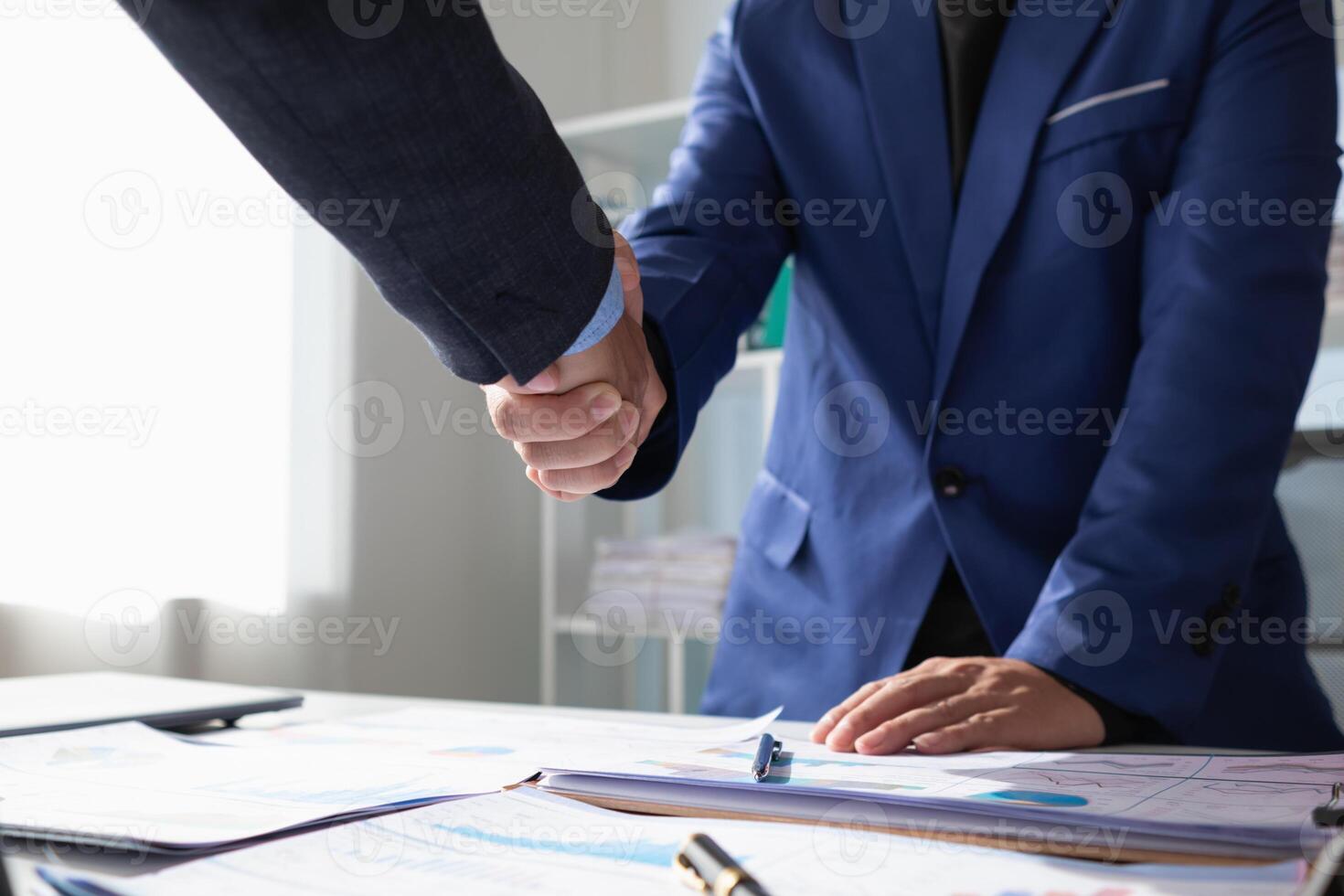 committee of businessmen and investors join hands as symbol of joint investment after discussing consulting and making contract  invest in business together. committee joins hands in meeting. photo