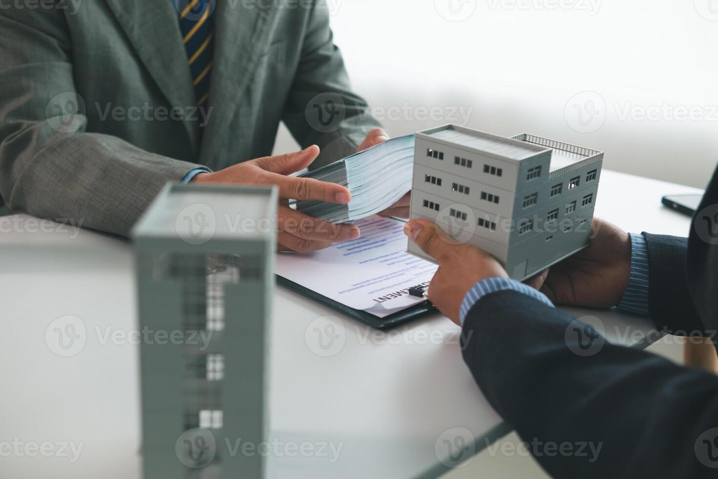 Real estate agents are selling real estate clients and offering condominiums buyers as long term rental investments help reduce burden paying installments. Investment property trading long term rental photo
