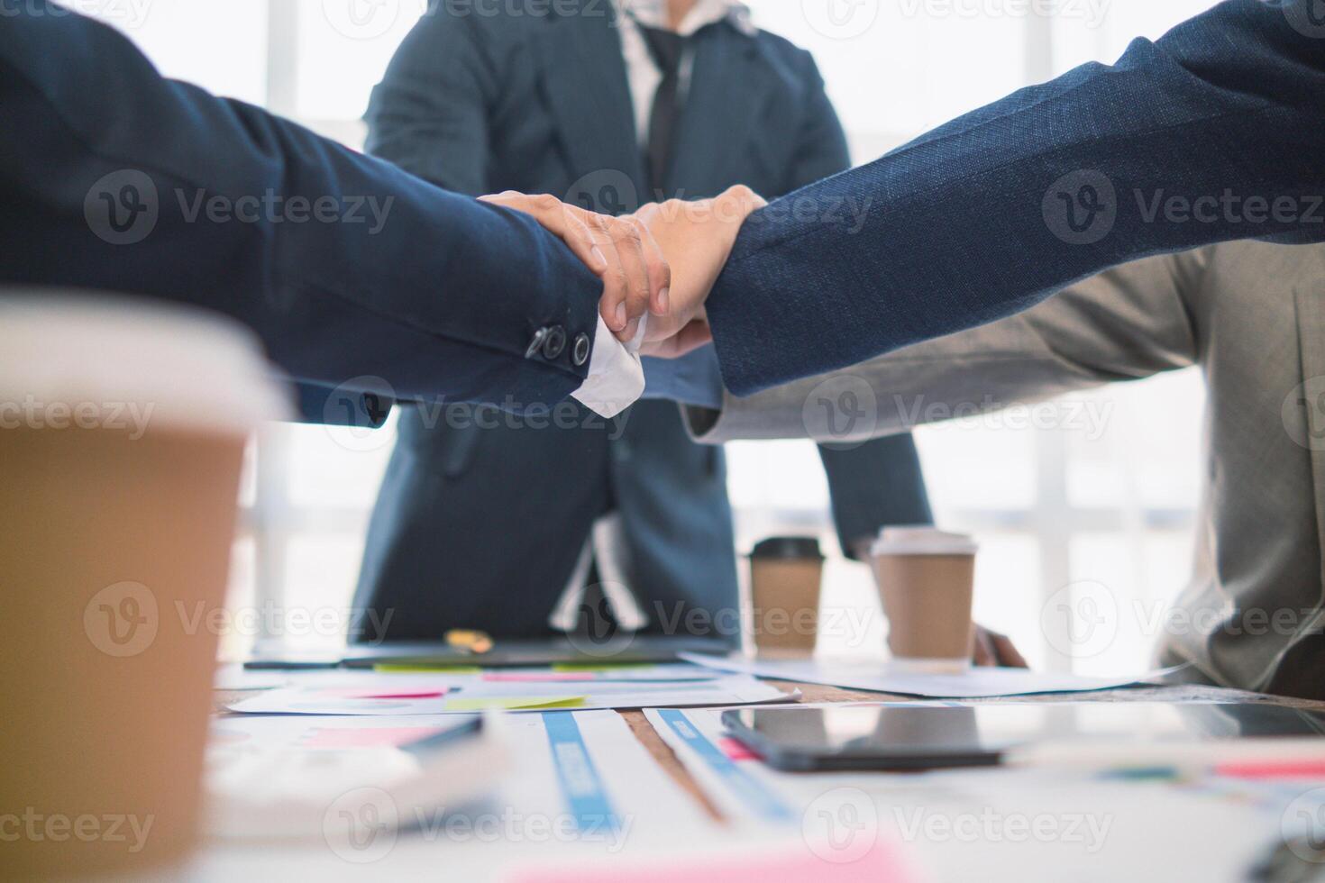 Businessmen and investors shake hands as symbol of joint venture after discussing, consulting and making contract to invest in business together. business people shaking hands as symbol of cooperation photo