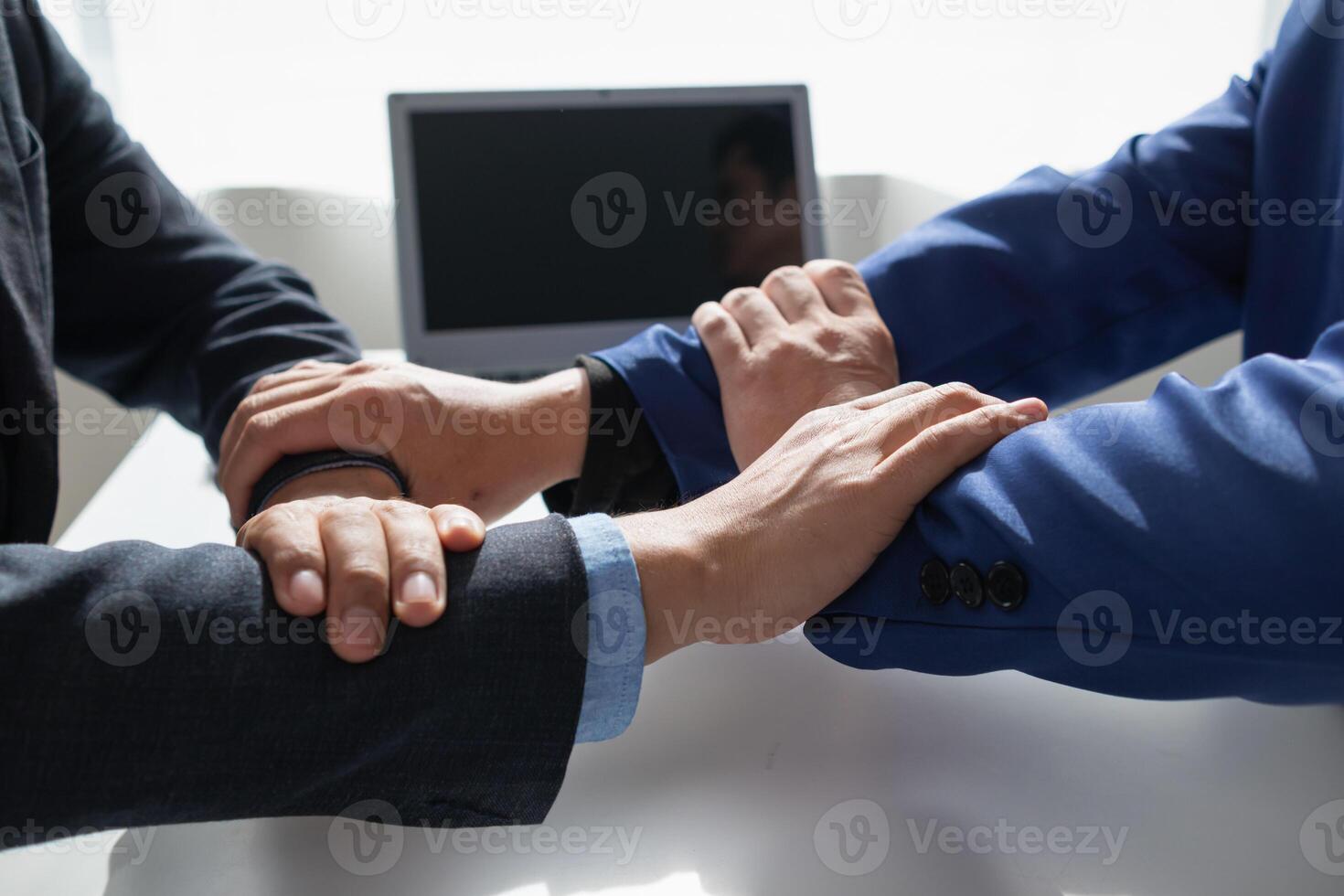 Businessmen and investors shake hands as symbol of joint venture after discussing, consulting and making contract to invest in business together. business people shaking hands as symbol of cooperation photo