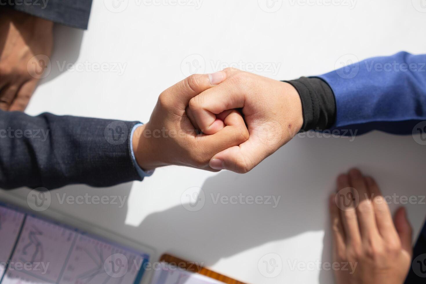 Businessmen and investors shake hands as symbol of joint venture after discussing, consulting and making contract to invest in business together. business people shaking hands as symbol of cooperation photo