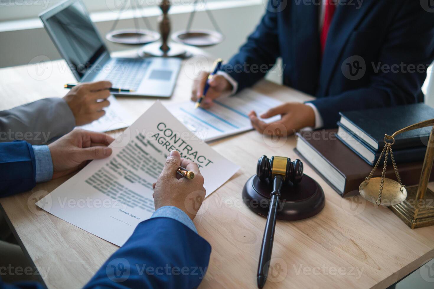 Businessmen and investors discussed joint venture within the legal counsel office and agreed to sign a contract in front of the lawyers within the legal counsel office to witness the joint investment. photo