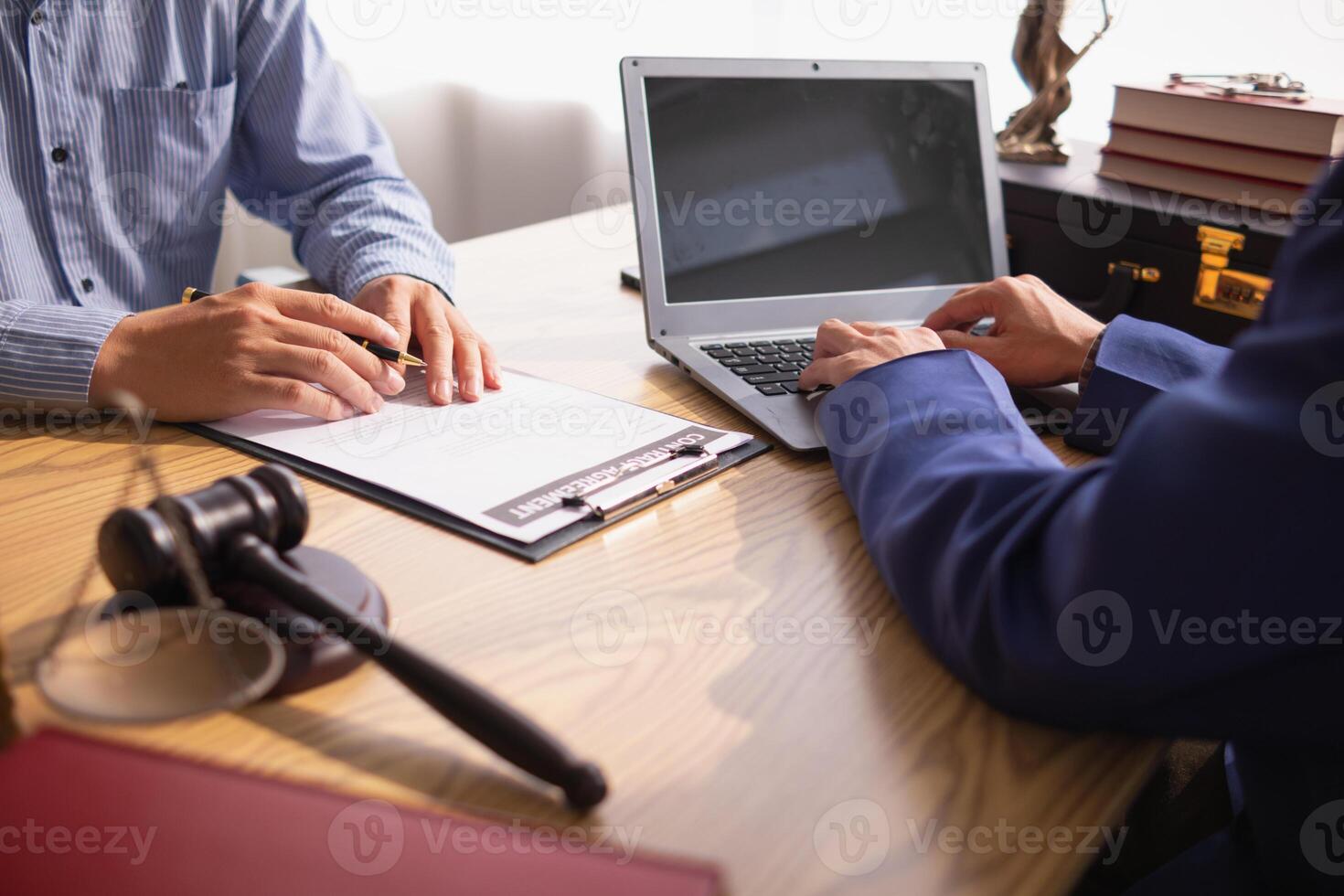 contract was placed on table inside legal counsel's office, ready for investors to sign the contract to hire a team of lawyers to provide legal advice for their investment. legal consulting concept photo
