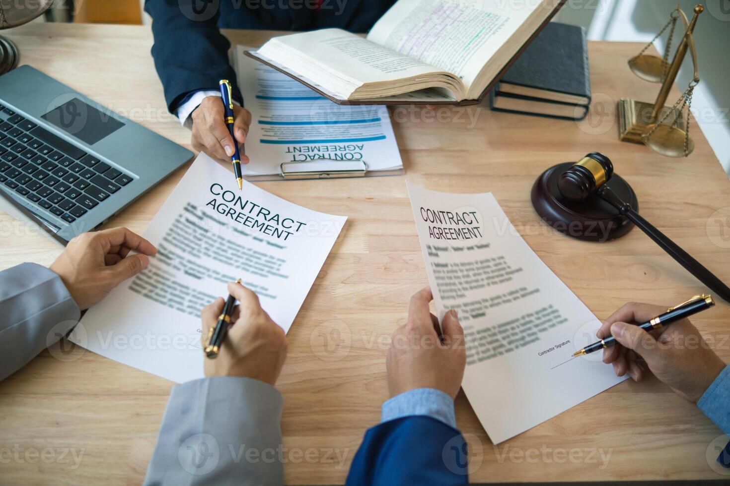 Businessmen and investors discussed joint venture within the legal counsel office and agreed to sign a contract in front of the lawyers within the legal counsel office to witness the joint investment. photo