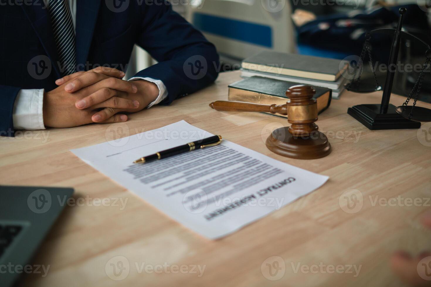 contract was placed on table inside legal counsel's office, ready for investors to sign the contract to hire a team of lawyers to provide legal advice for their investment. legal consulting concept photo