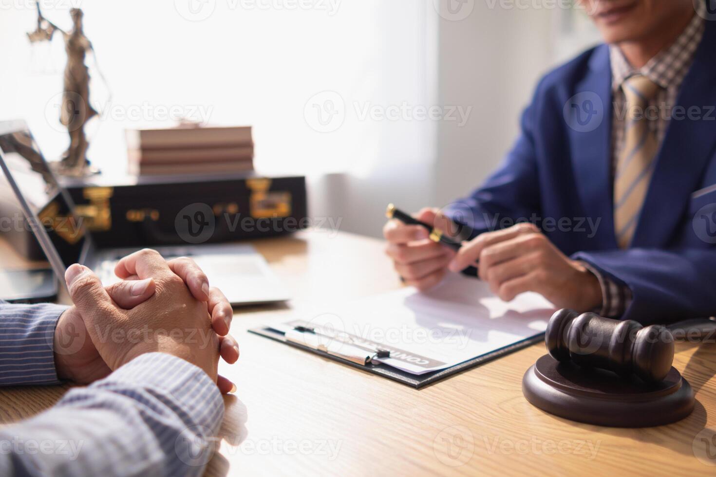 contract was placed on table inside legal counsel's office, ready for investors to sign the contract to hire a team of lawyers to provide legal advice for their investment. legal consulting concept photo