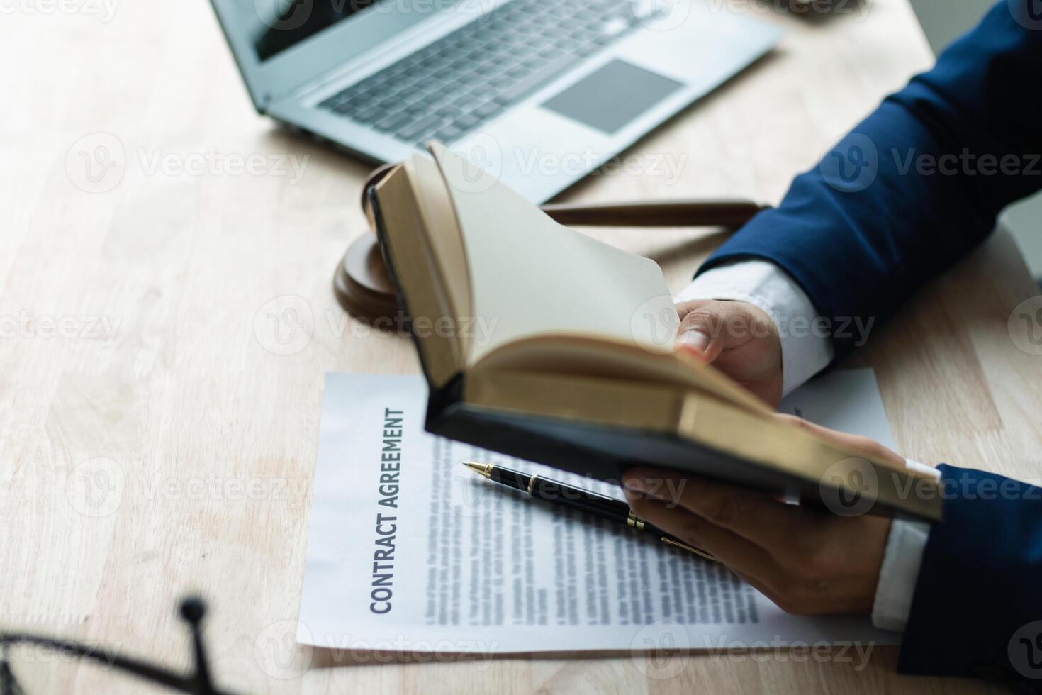 young lawyer was flipping through Bible in his legal office just to learn about God teachings from the Bible and to be reminded to do what is right. The concept of belief and the power of faith in God photo