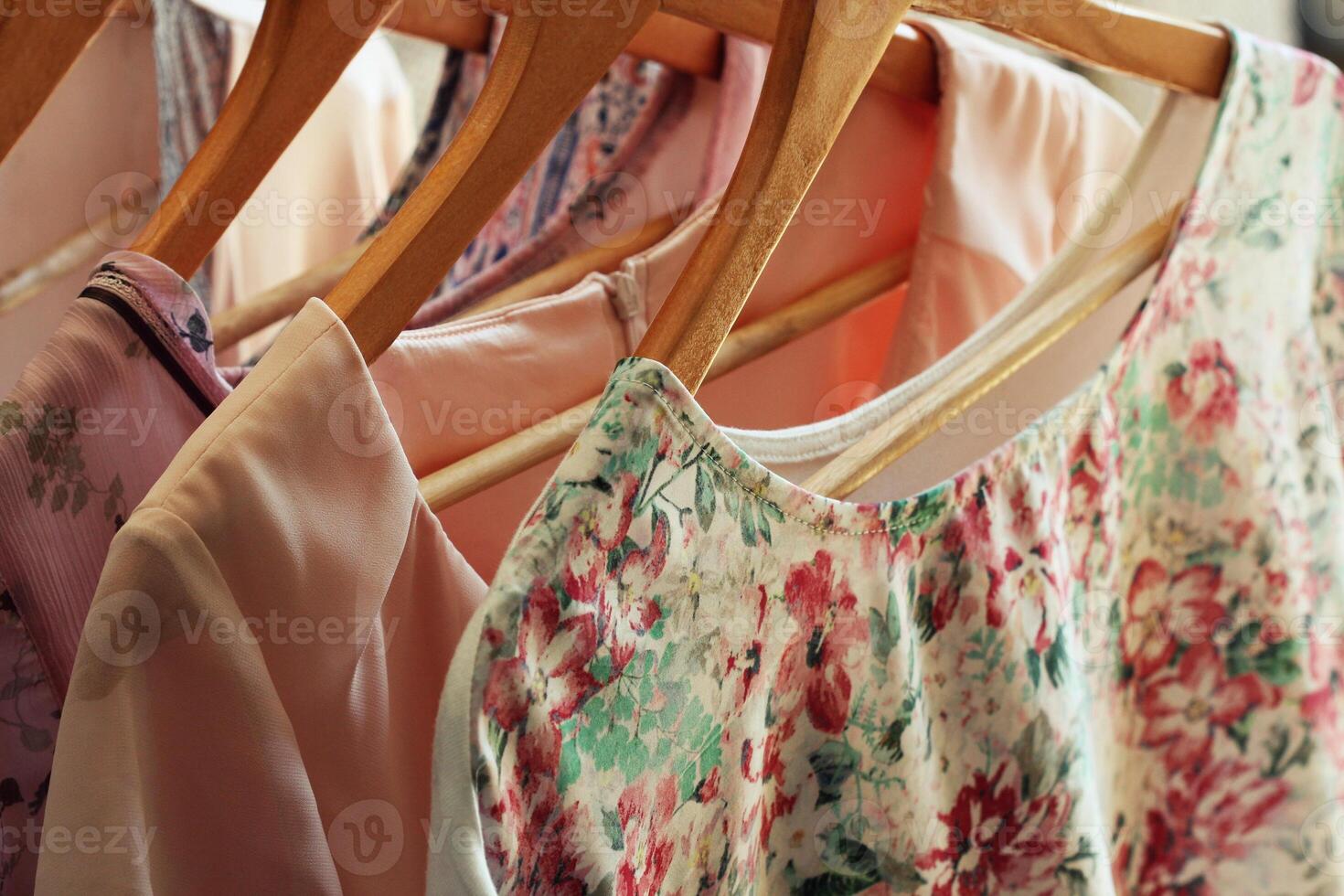 collection of women's clothes hanging on rack photo