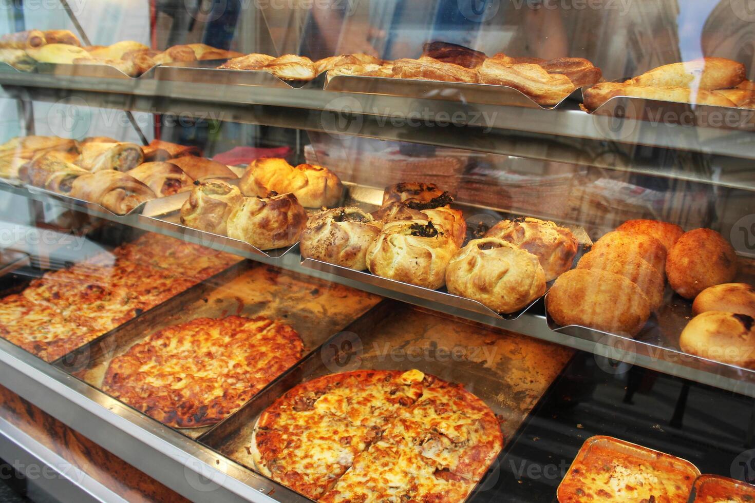 Traditional savoury pastry with filling. Fresh pastizzi and snacks for sale in a pastizzeria. Malta photo