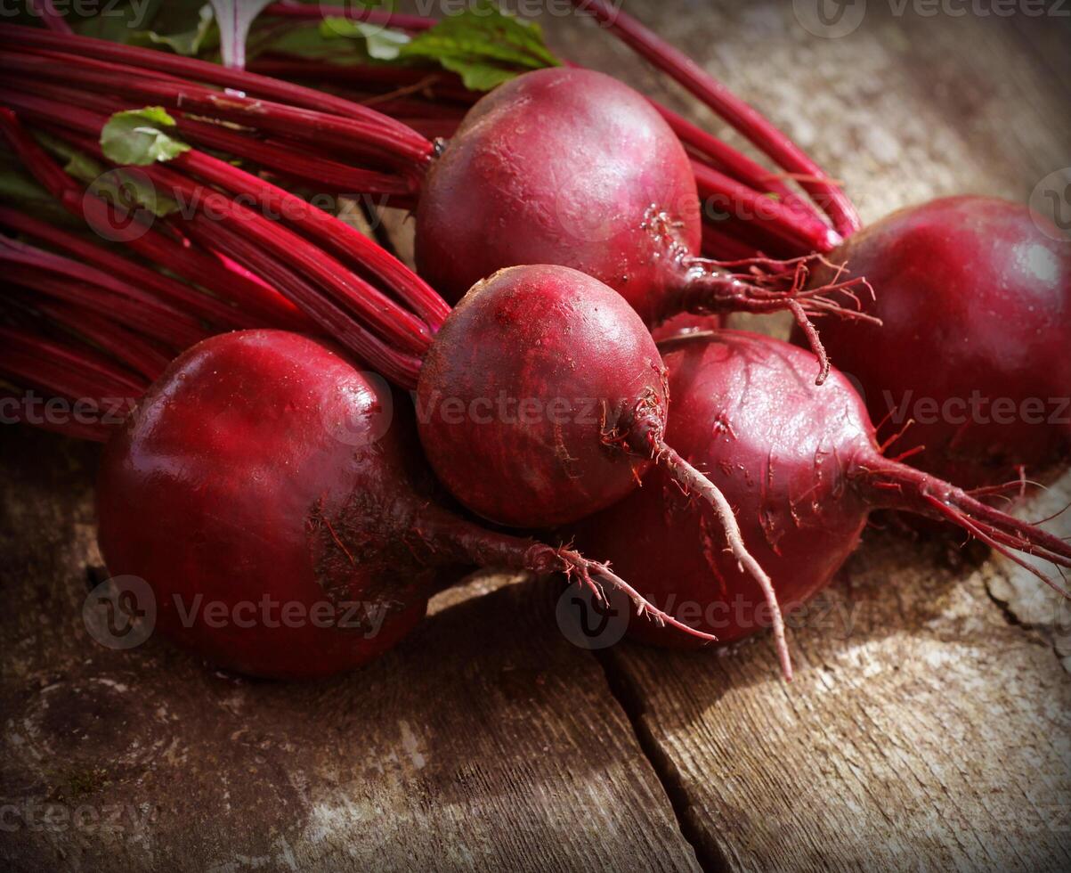 Fresh beetroot on rustic wooden background. Harvest vegetable cooking conception . Diet or vegetarian food concept photo