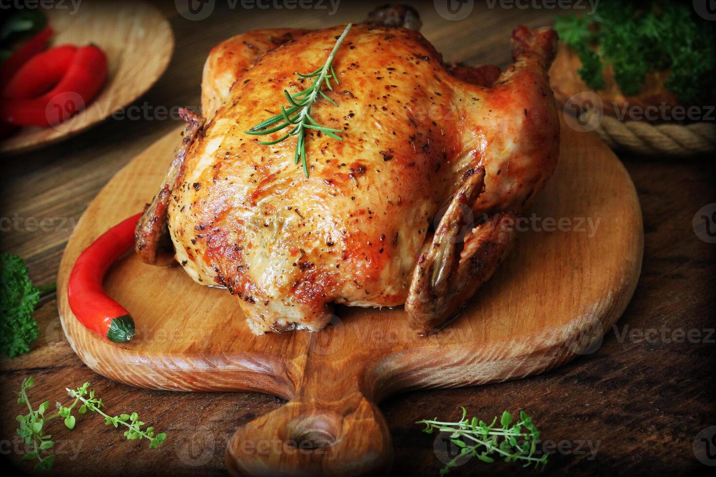 Whole roasted chicken on cutting board photo