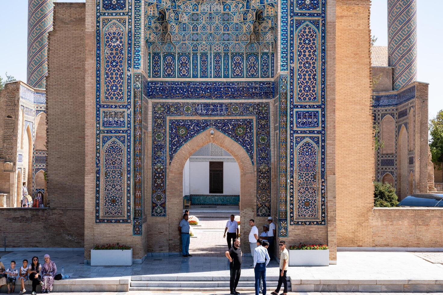 Tashkent, Uzbekistan-august 12, 2023-people in front of the entrance of the 15th century Tamerlane Mausoleum with decorated tombs, mosaics and carvings during a sunny day photo