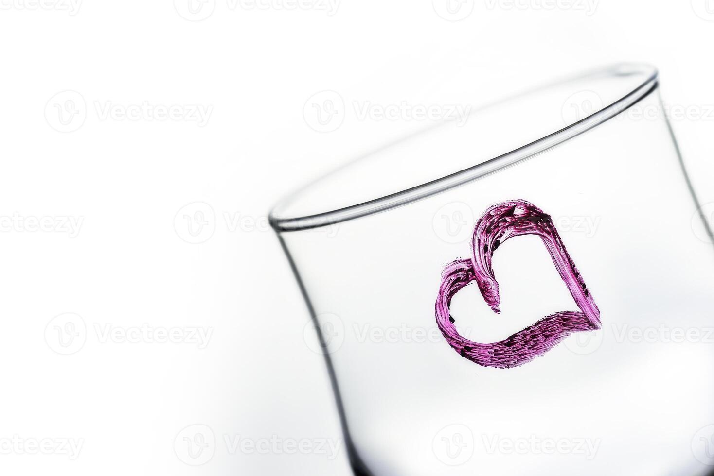 One glass with heart shape in purple color photo