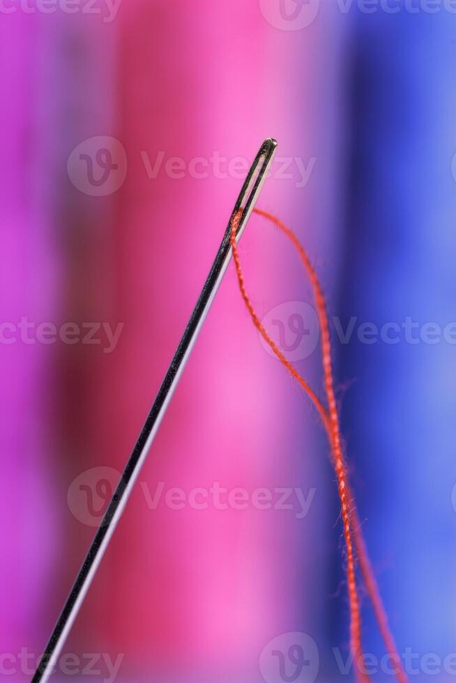 Close-up view of one needle with red thread photo