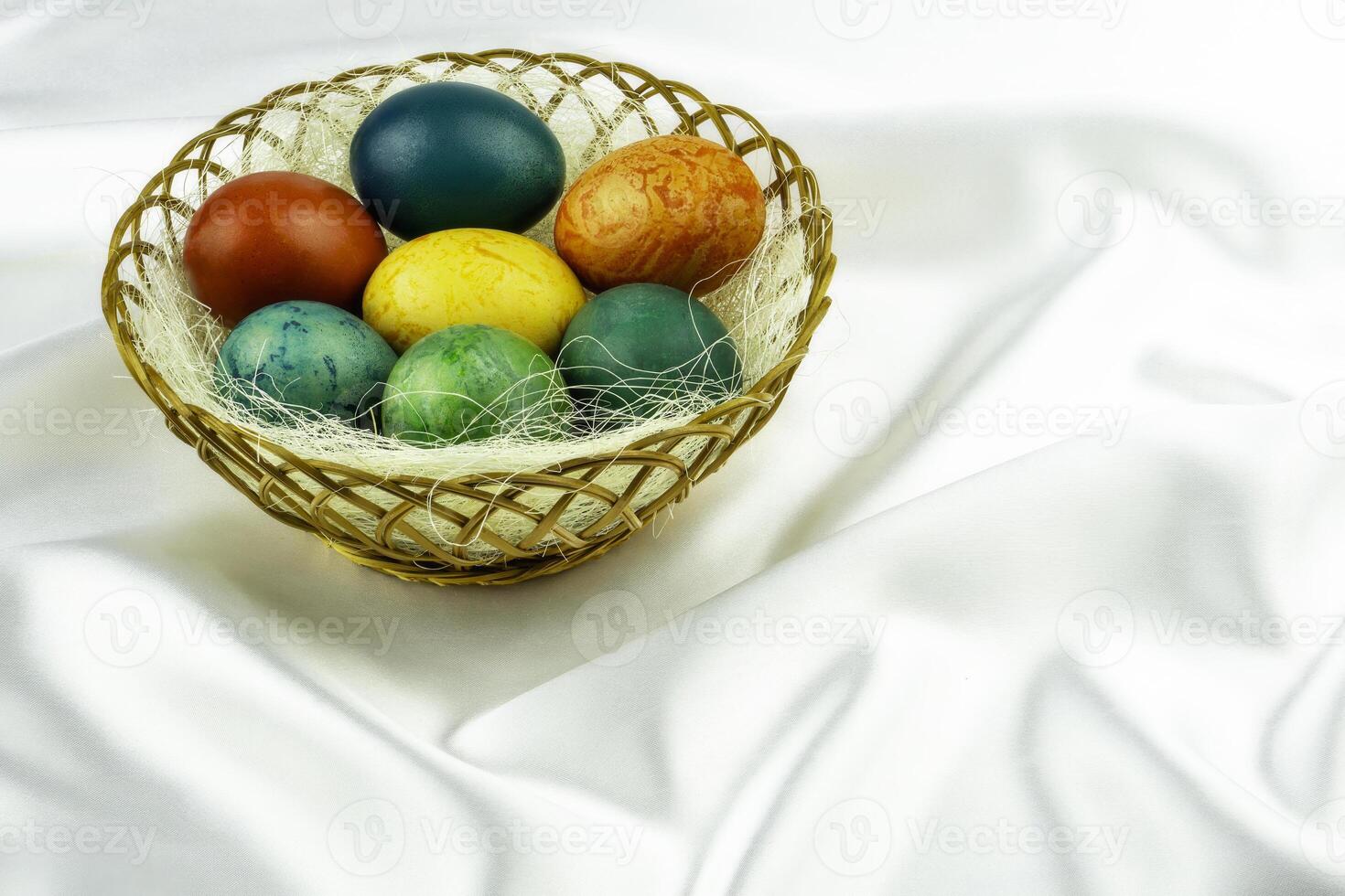 Differently colored Easter eggs in a basket photo